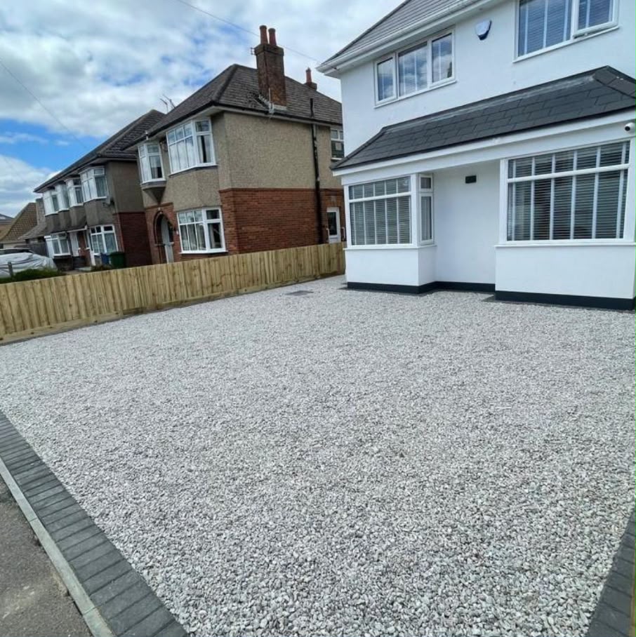 Black and grey decorative gravel side driveway with block paving edge