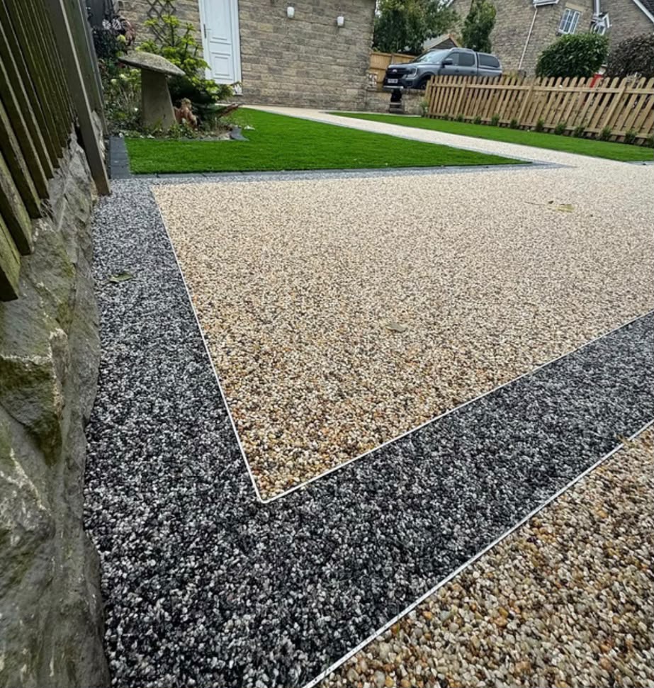 Beige resin bound driveway with tumbled block soldier course border