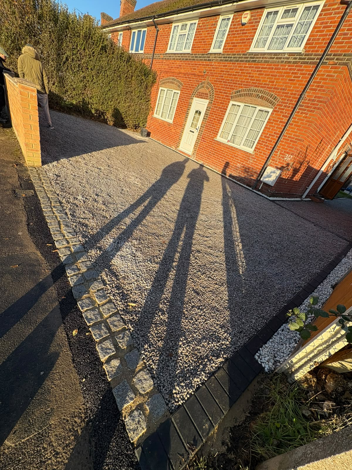 Completed resin bound driveway with soldier course border to the front of a home