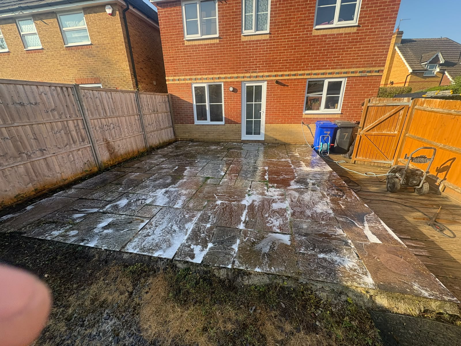 Indian sandstone patio being pressure washed to remove moss and algae